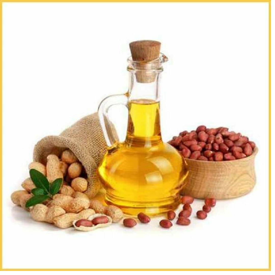 Groundnut oil bottle and peanuts